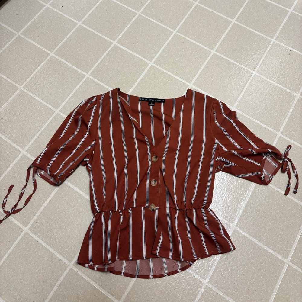 Burnt orange buttoned top with black and white stripes